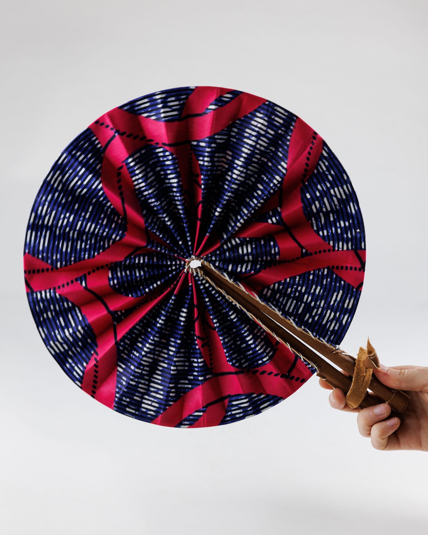 Fan- Collapses for easy storage, made from African wax fabric