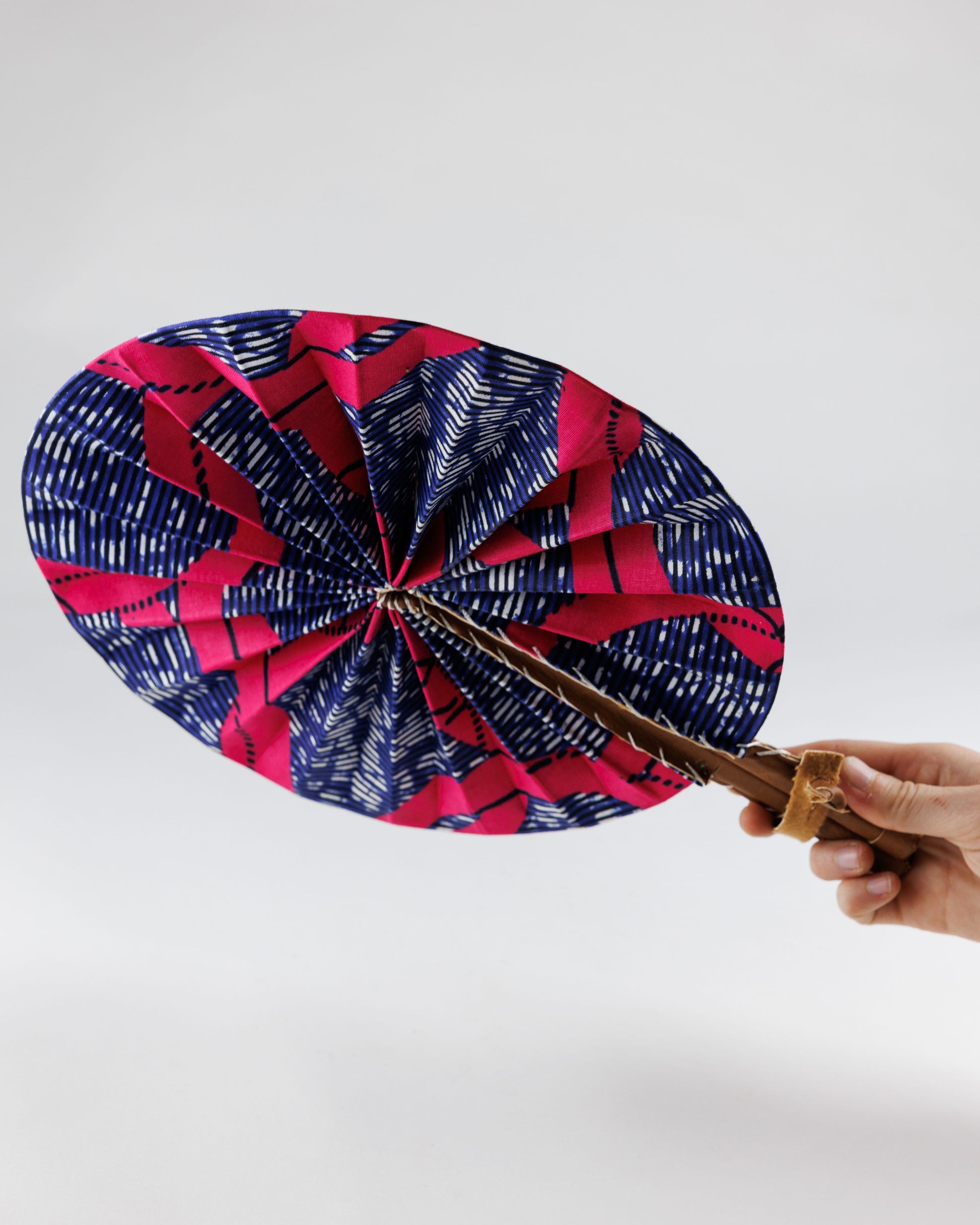 Fan- Collapses for easy storage, made from African wax fabric