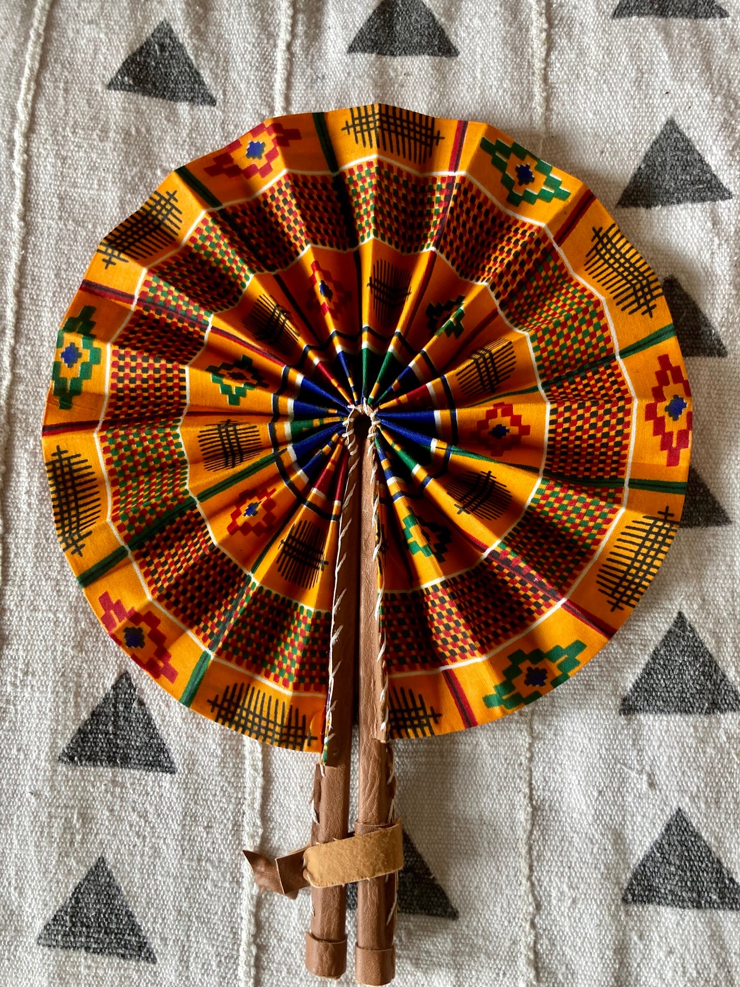 Fan- Collapses for easy storage, made from African wax fabric