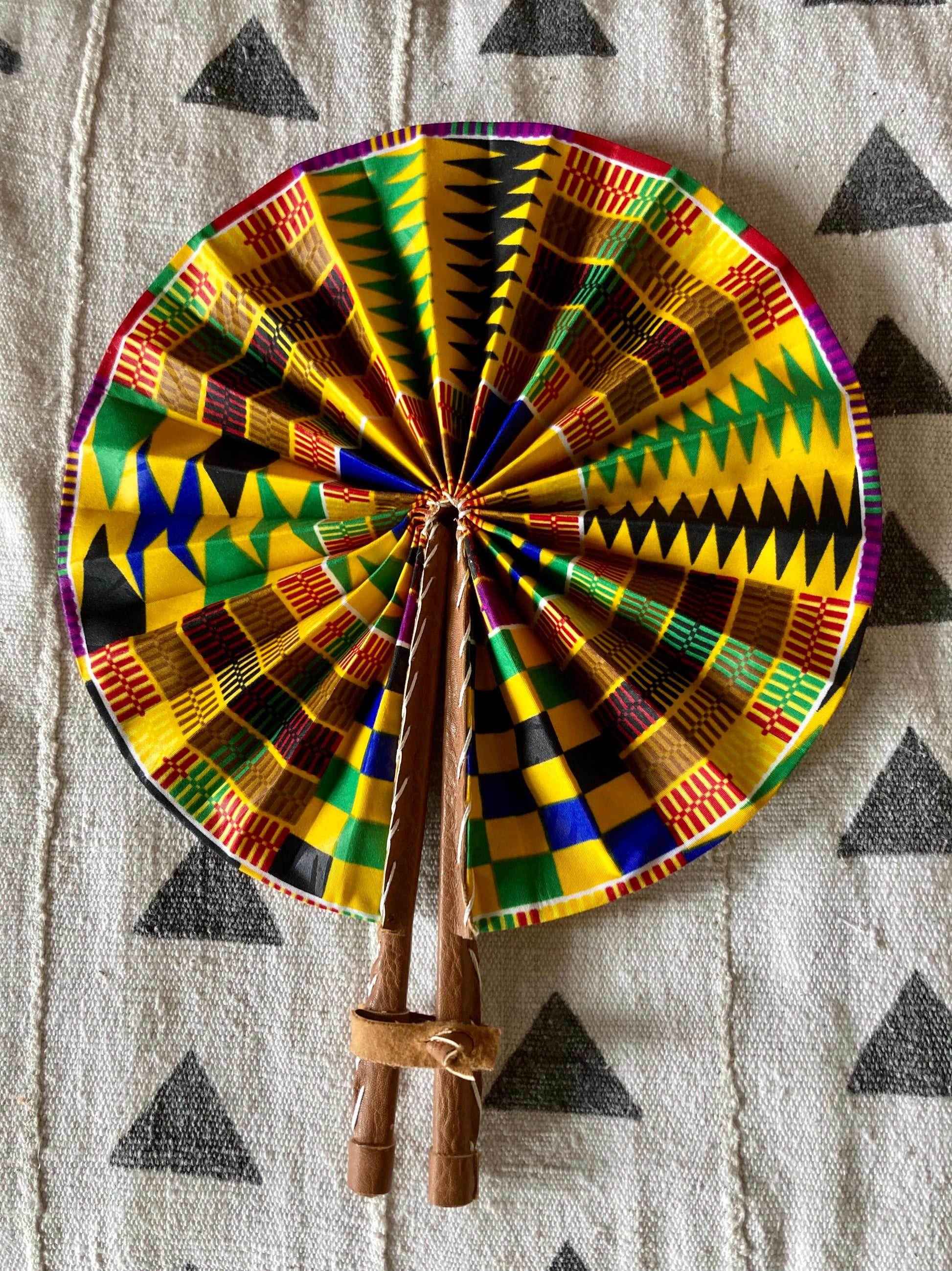 Fan- Collapses for easy storage, made from African wax fabric