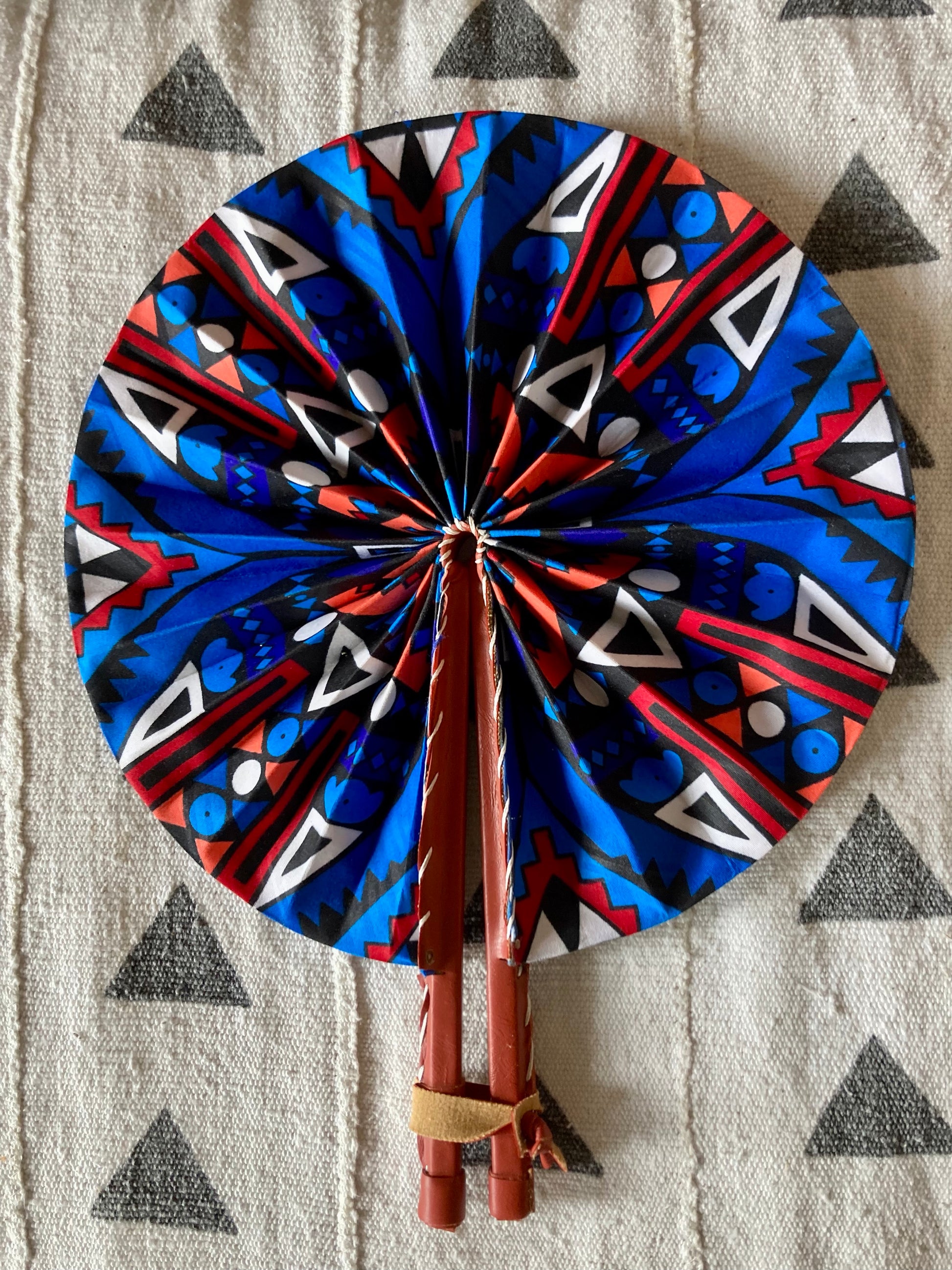 Fan- Collapses for easy storage, made from African wax fabric